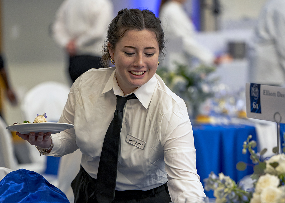 A student serving meals at A Night in the Valley