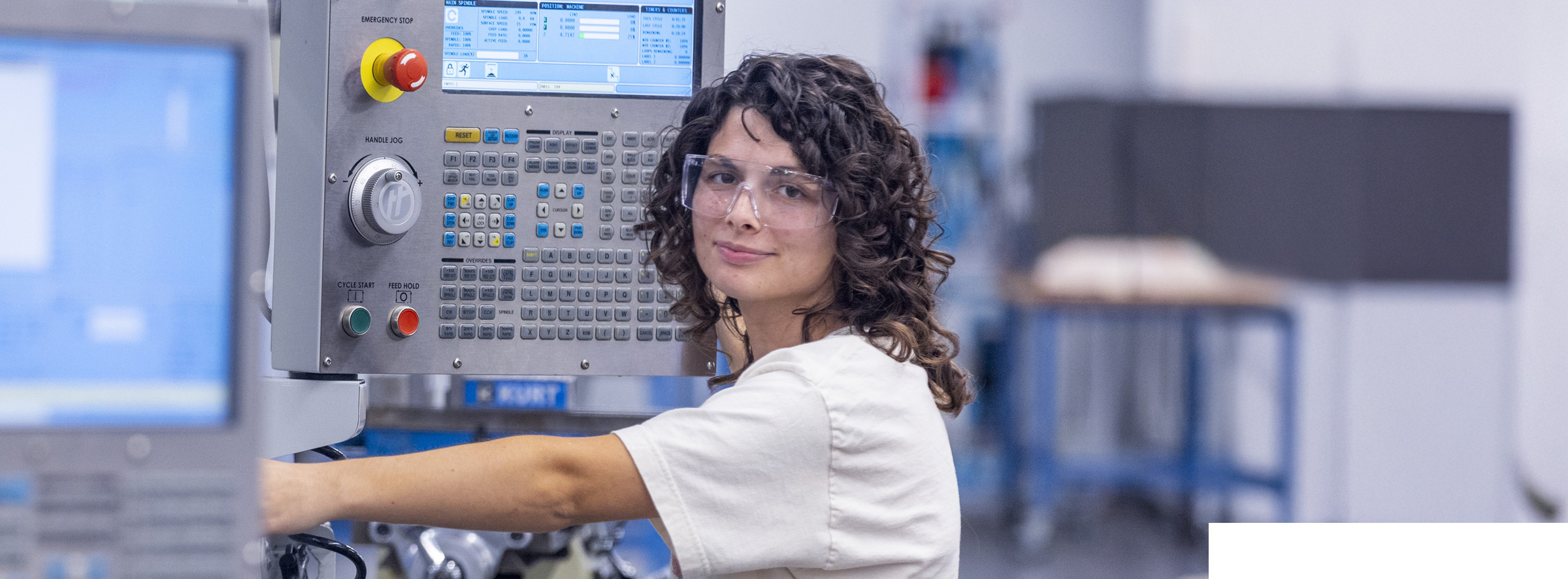 Student operating a CNC machine in a manufacturing technology lab
