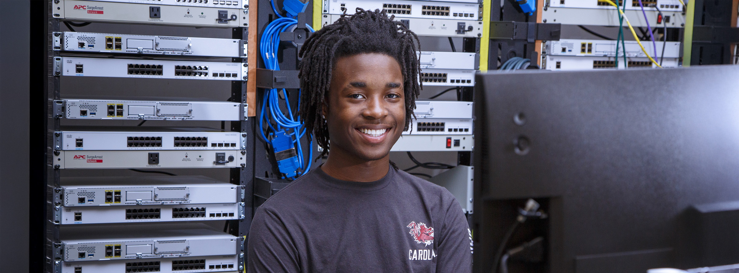 Student working with network server equipment in a computer lab