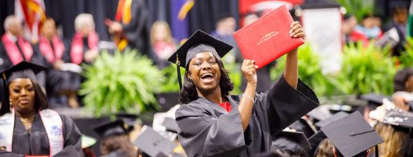 Student holding diploma.