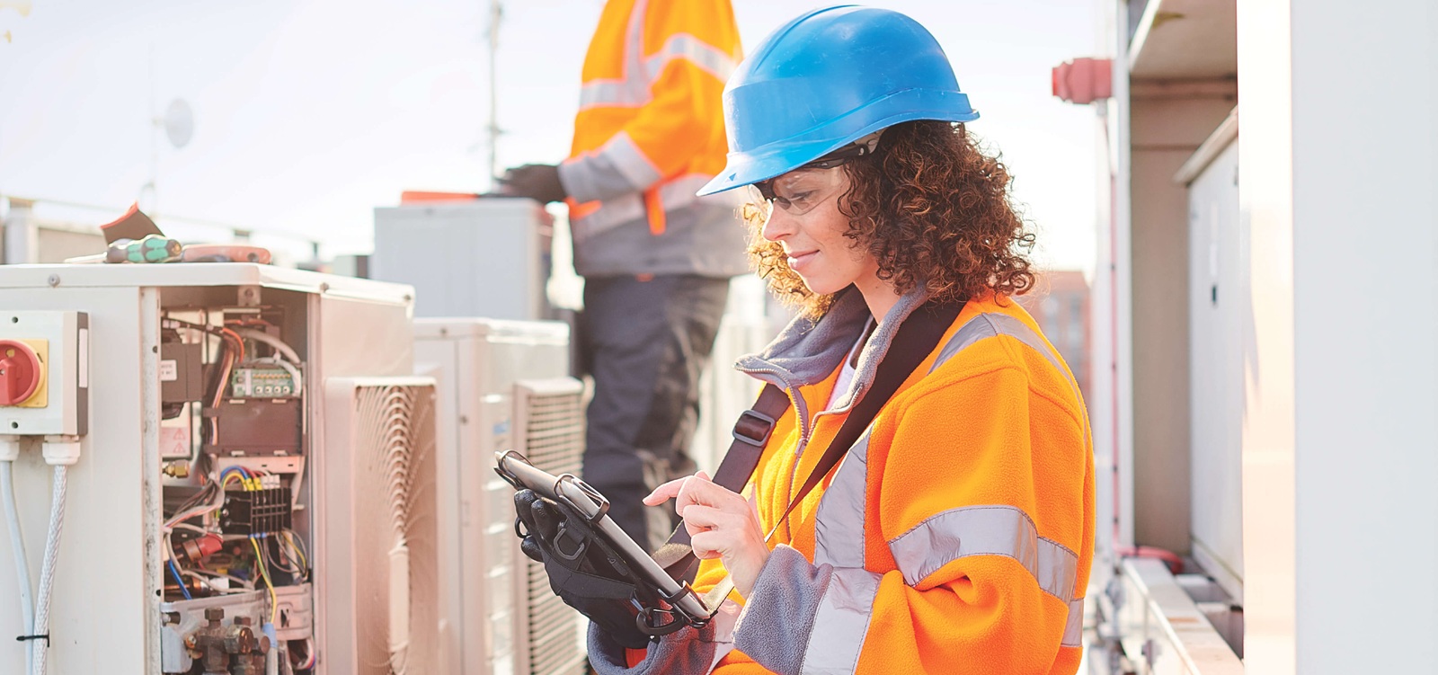 Female tech working on HVAC unit Female tech working on HVAC unit
