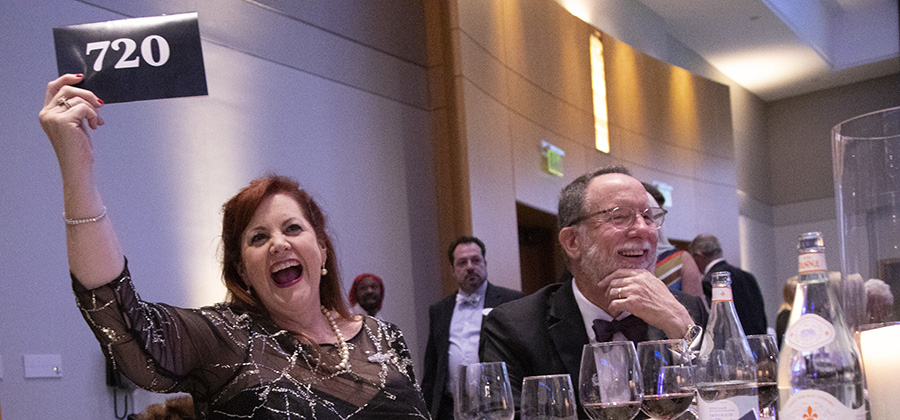 A guest raising a bid paddle during the auction.