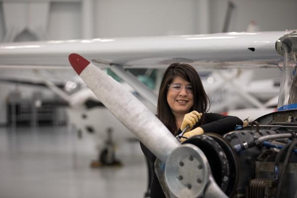 Female student working on airplane