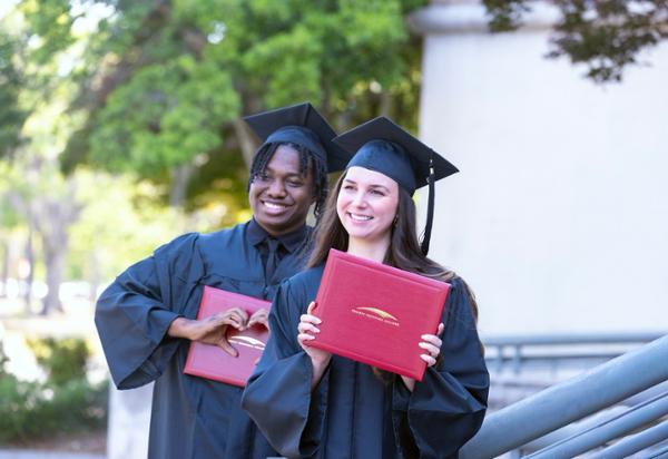 Male and female graduate celebrate
