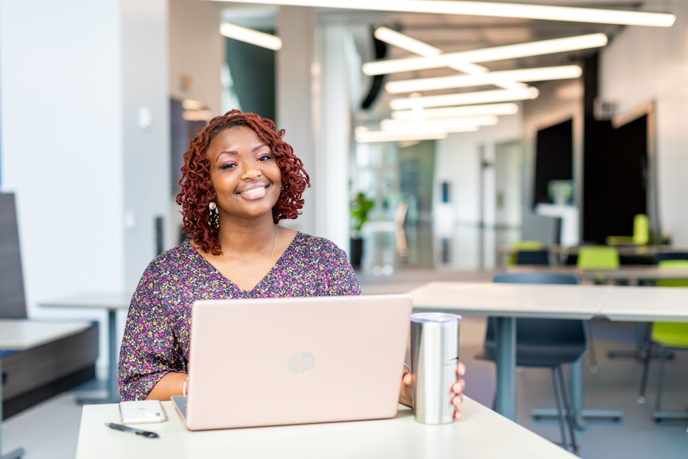 Female student with laptop and drink