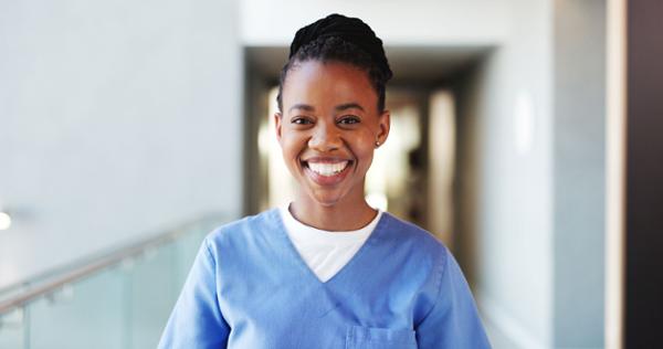 Smiling young female medical assistant wearing scrubs